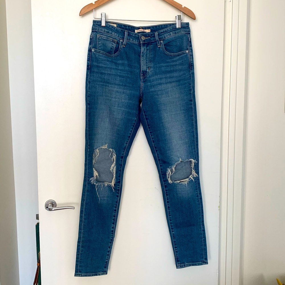Levi’s 721 high rise skinny jeans with rips in the knees, mint condition.